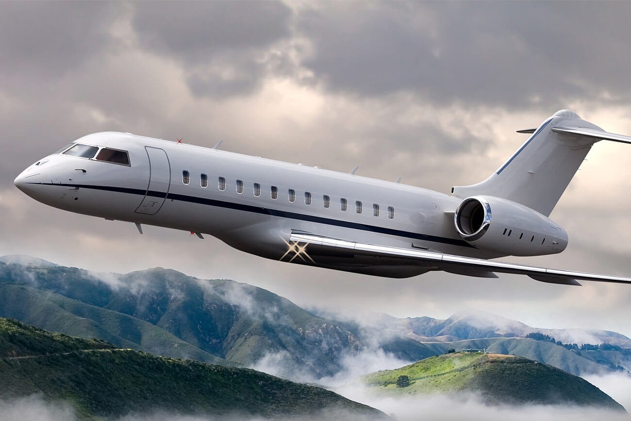 Private jet flying over mountains